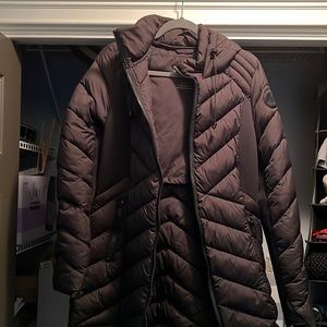 Puffy, long coat with hood …. Collapses into a backpack.